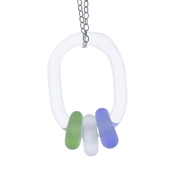 Close up of clear glass link passing through 3 frosted beads. The beads are blue, clear and green. The link hangs on a sterling silver chain. White background.