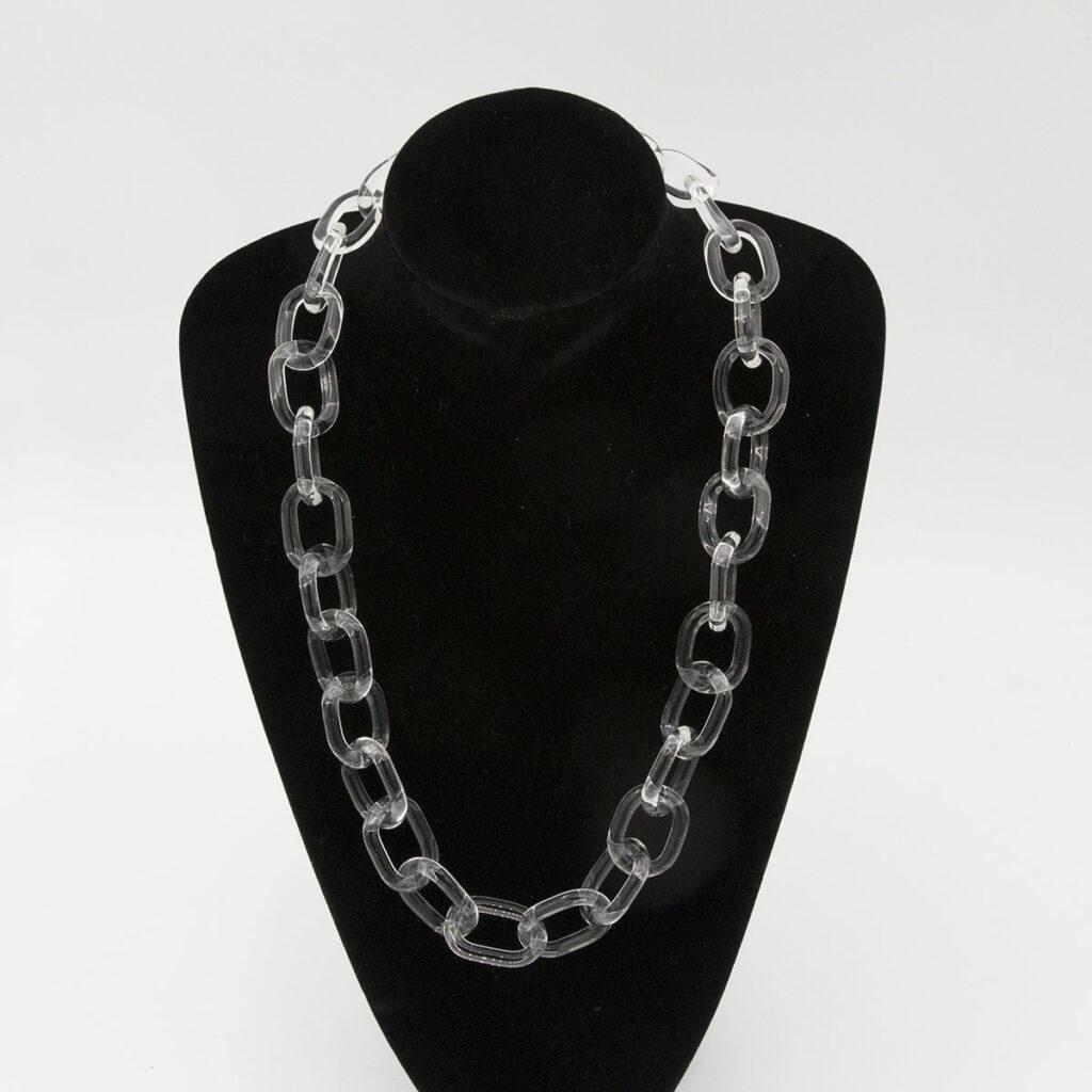 Bold glass chain necklace made from links of clear glass. Shown on a black velvet mannequin.