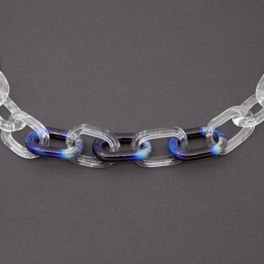 Close up of necklace made from clear glass links with three coloured links at the front. The links are made from dragons eye glass which is multicoloured with pale blue, blue and purple.