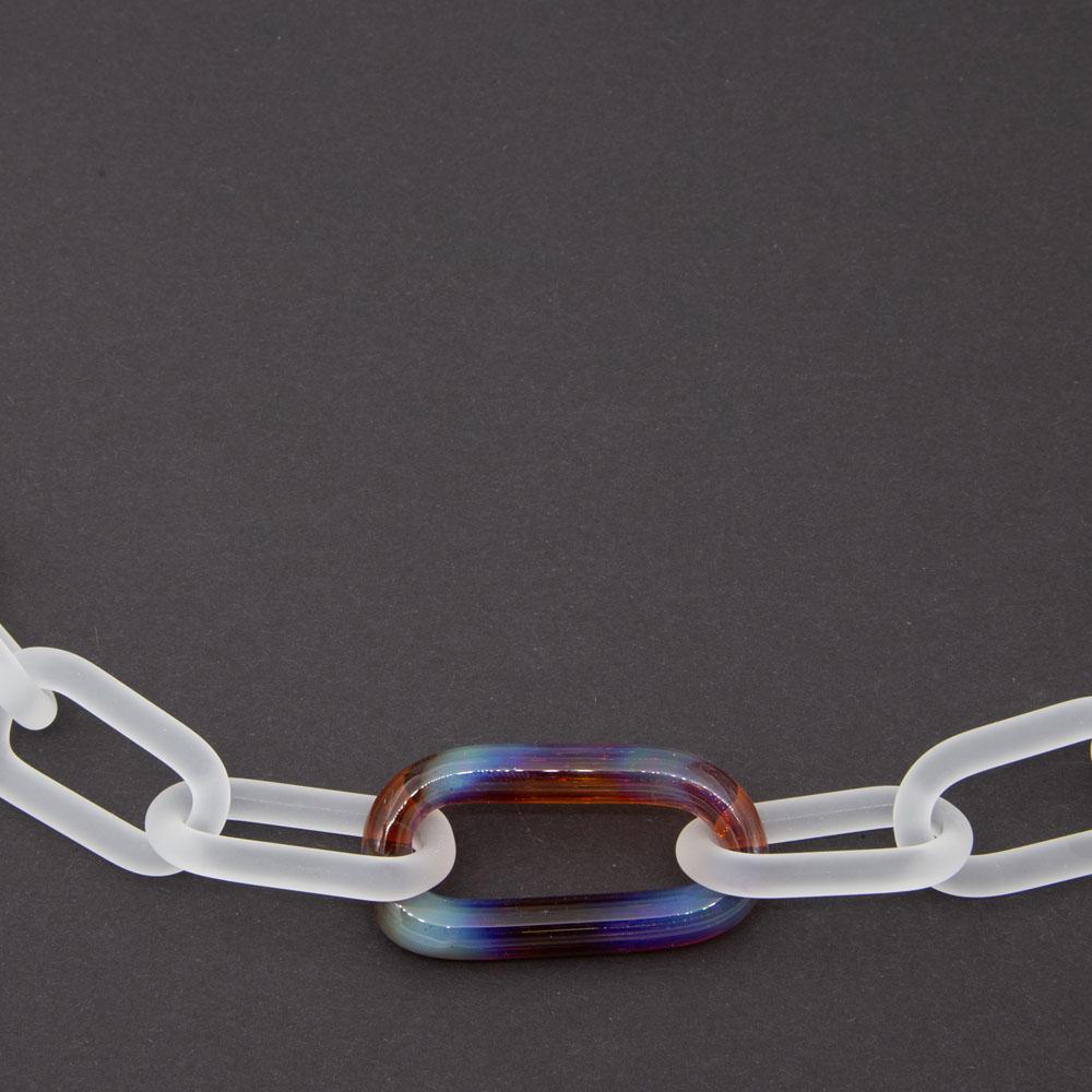 Close up of lass chain necklace made with frosted links of clear glass and a single link of multicolour pink, purple, blue and copper glass.