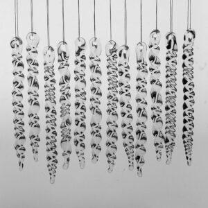12 large clear glass icicles with hanging loop and twist design. The icicles hand in front of a pale grey background.
