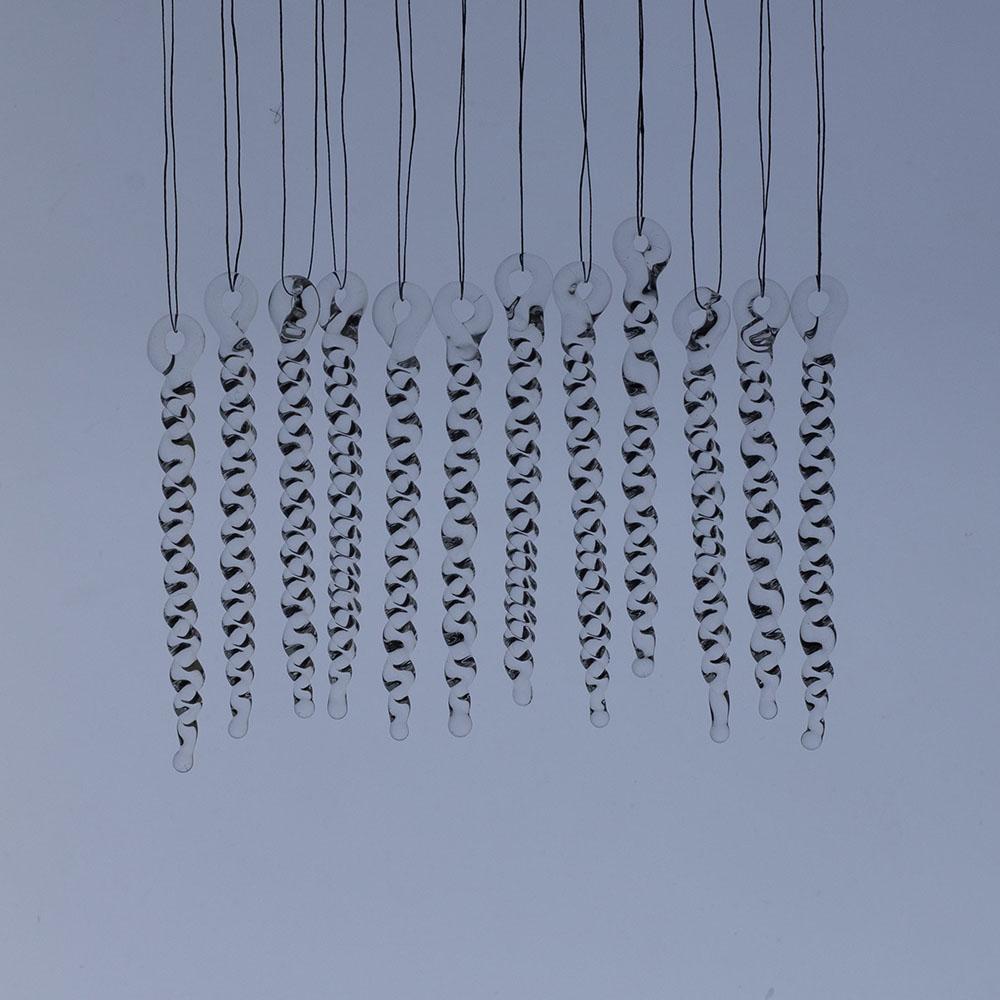 12 tiny clear glass icicles with hanging loop and twist design. The icicles hand in front of a frosty blue background.