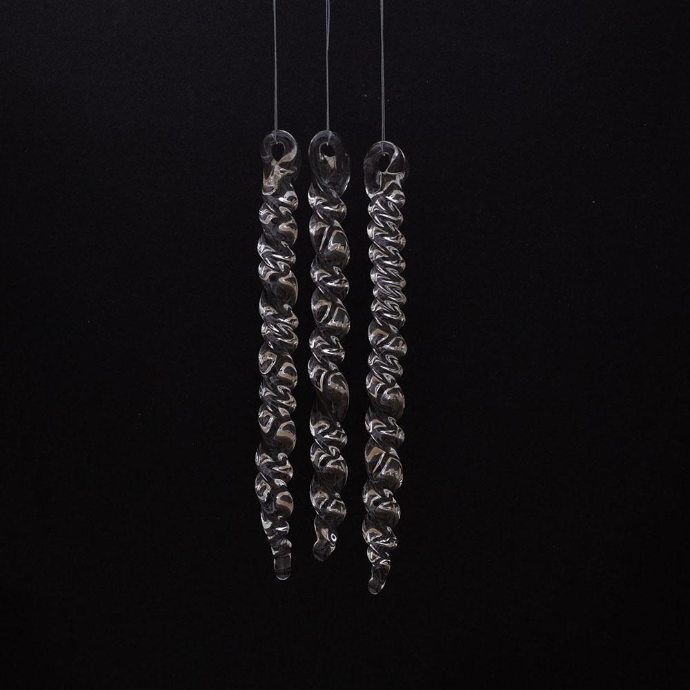 3 large clear glass icicles with hanging loop and twist design. The icicles hand in front of a black background.