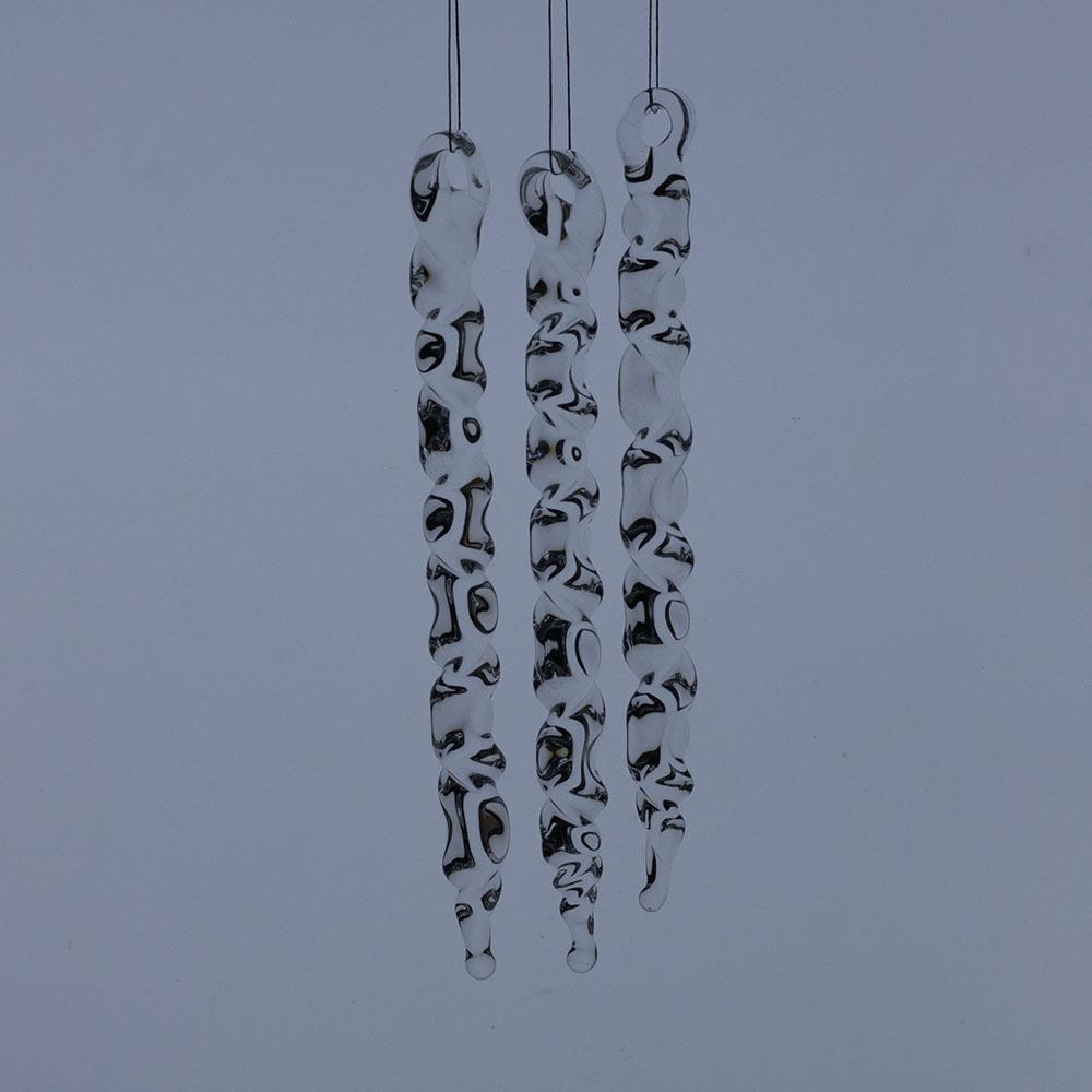 3 large clear glass icicles with hanging loop and zig zag design. The icicles hand in front of a frosty blue background.