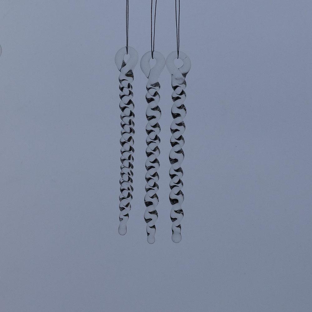 3 tiny clear glass icicles with hanging loop and twist design. The icicles hand in front of a frosty blue background.