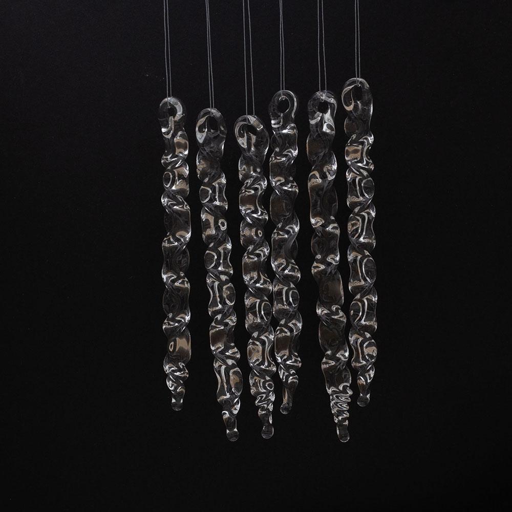 6 large clear glass icicles with hanging loop and zig zag design. The icicles hand in front of a black background.
