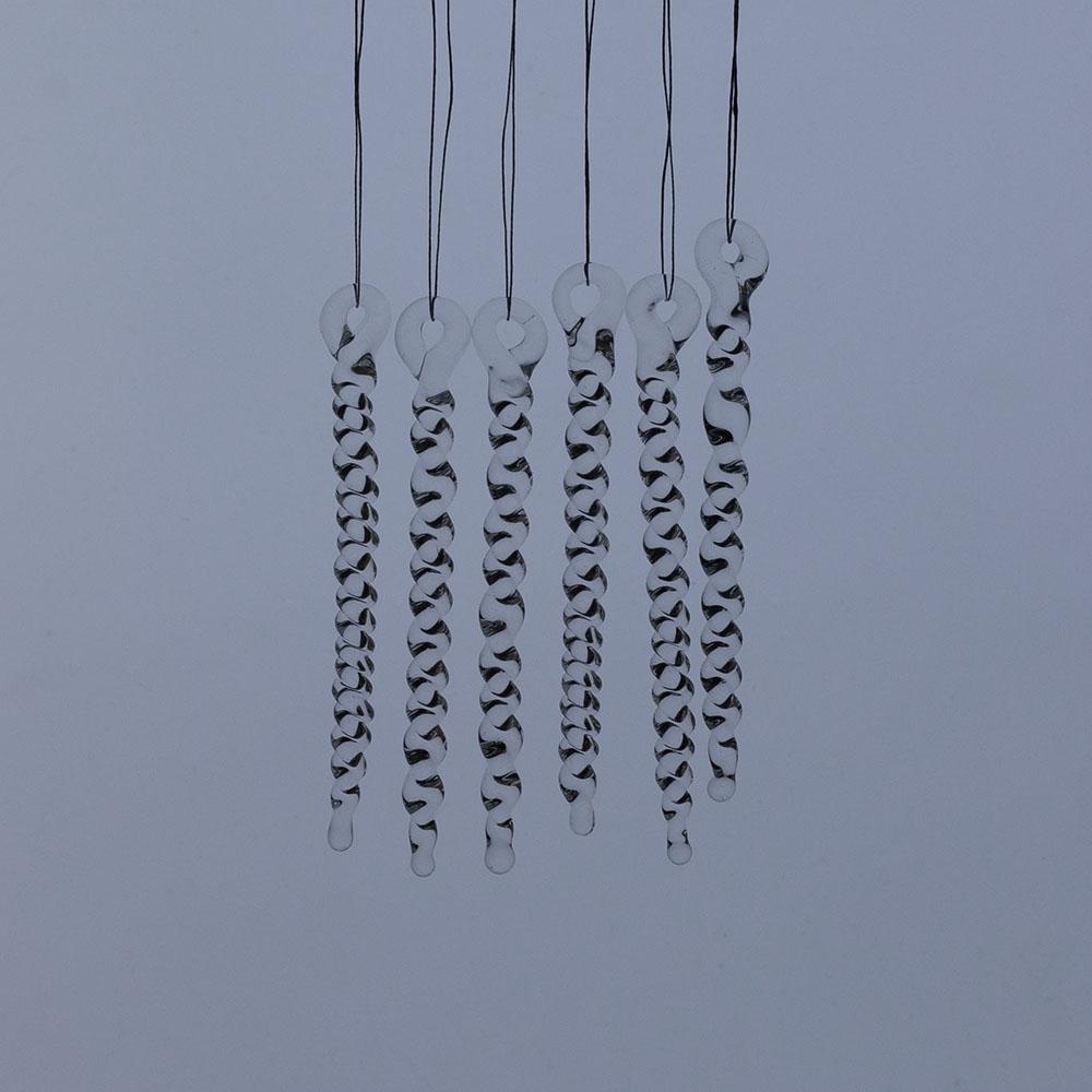 6 tiny clear glass icicles with hanging loop and twist design. The icicles hand in front of a frosty blue background.