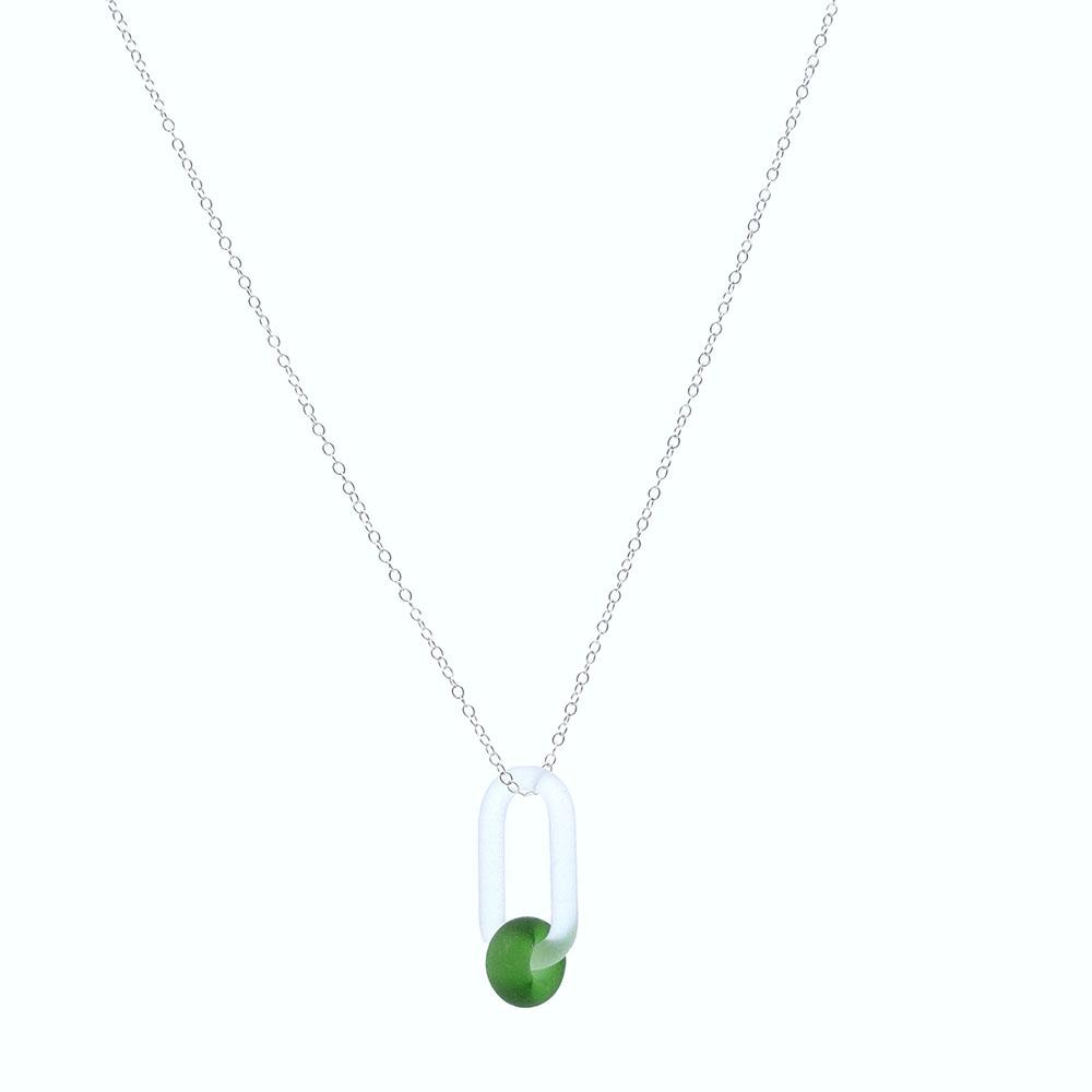 A clear glass link which passes through a bead made from a bright green Gordons gin bottle. Link and bead have a frosted finish. The link hangs from a fine sterling silver chain.