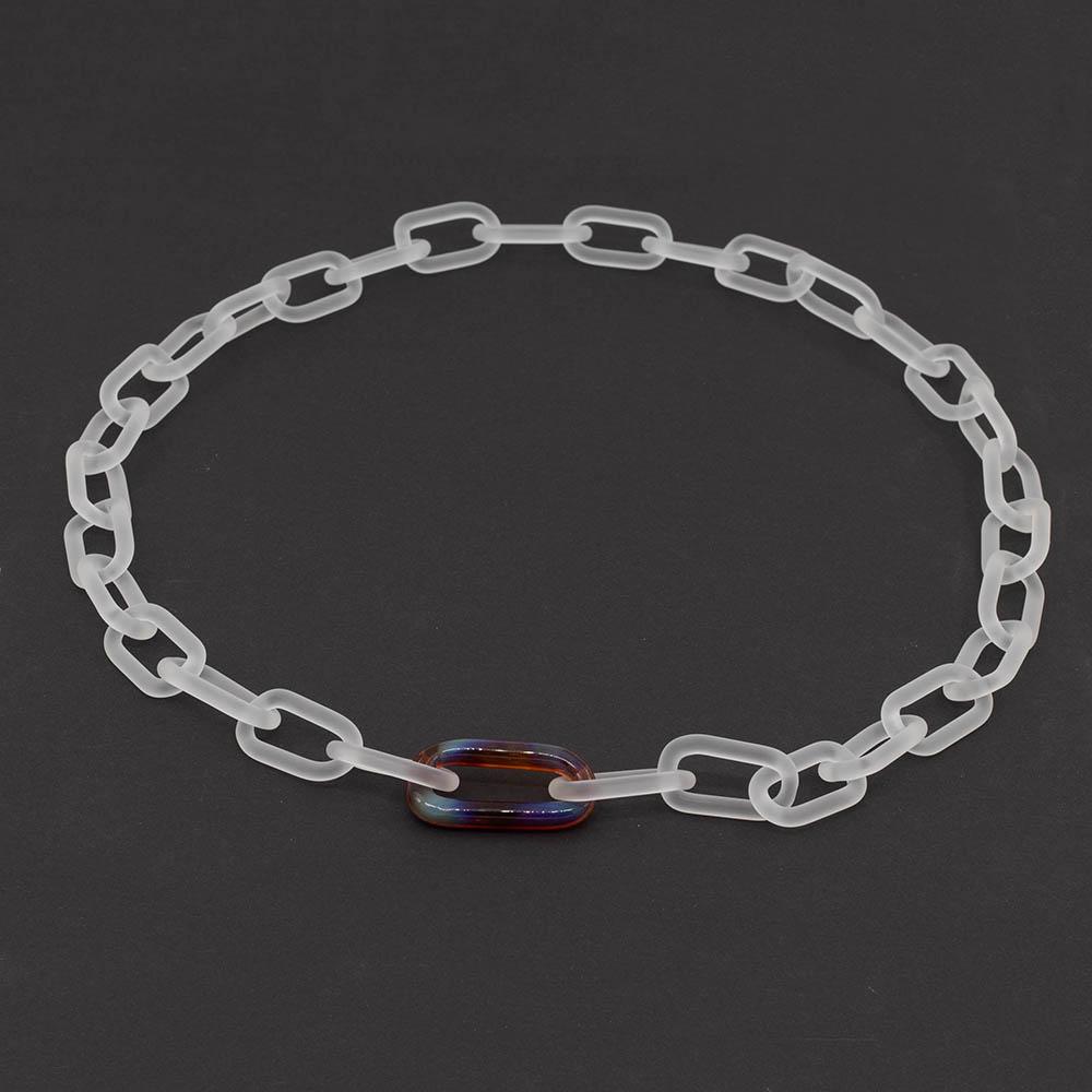 Frosted clear glass chain with multi colour link necklace sitting on a dark background.