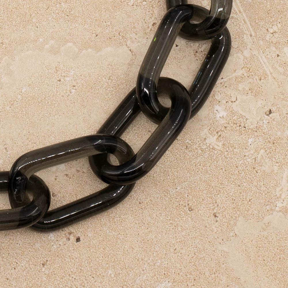 Close up of transparent black glass chain link necklace.