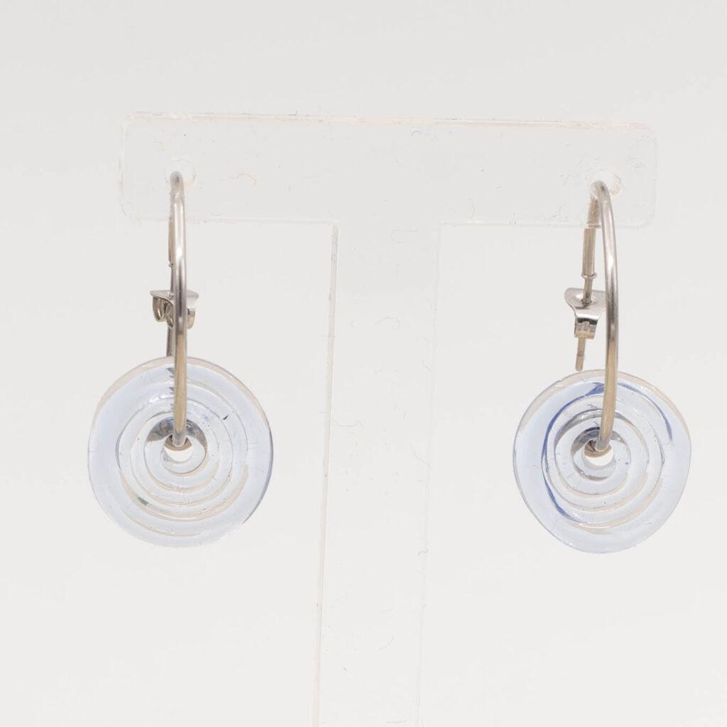 Front view of pale transparent blue glass disc hanging on a stainless steel hoop earring with a butterfly back.