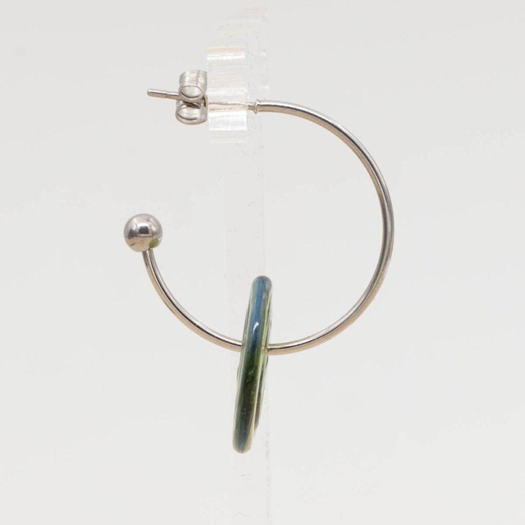Side view of sunshine light green disc hanging on a stainless steel hoop earring with a butterfly back.
