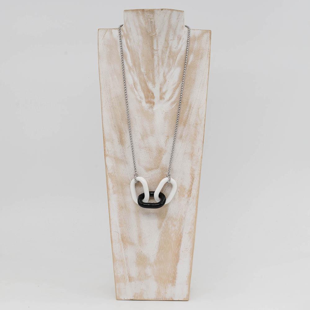 Necklace with three alternating white and black glass links. The links are fastened to a chain to make a necklace. Shown on a whitewashed wood torso.