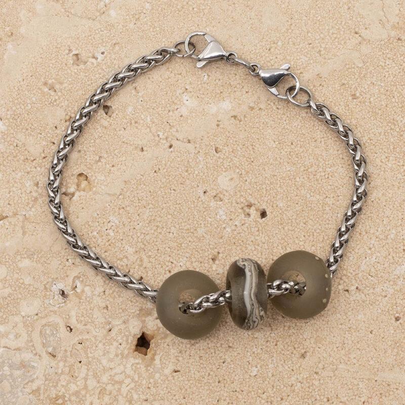 3 frosted grey glass beads with big holes on a stainless steel chain bracelet with double lobster clasp fastening.