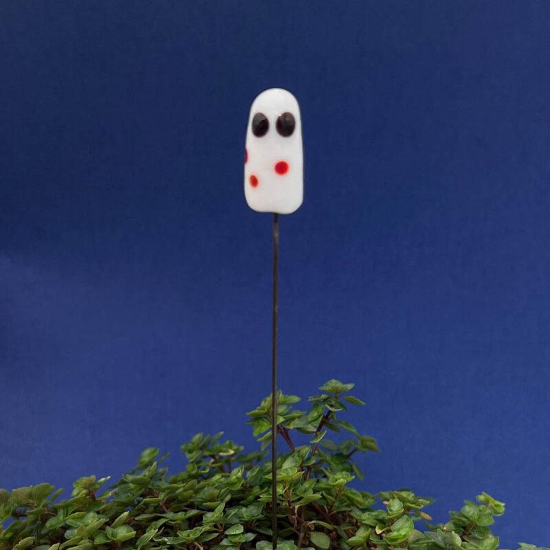 white ghost with red spots plant stake in a plant