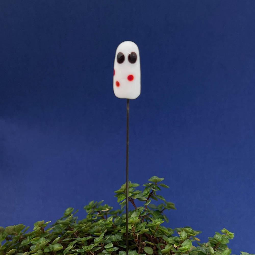 white ghost with red spots plant stake in a plant