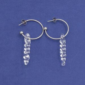 two large clear icicle glass icicles on round earring hoops with butterfly backs laid flat