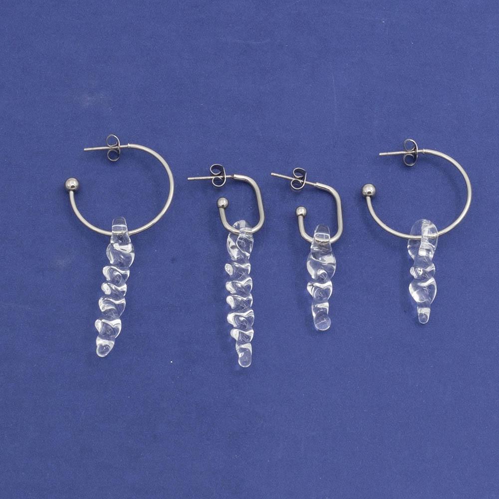 large and small clear icicle glass icicles on oval and round earring hoops with butterfly backs laid flat