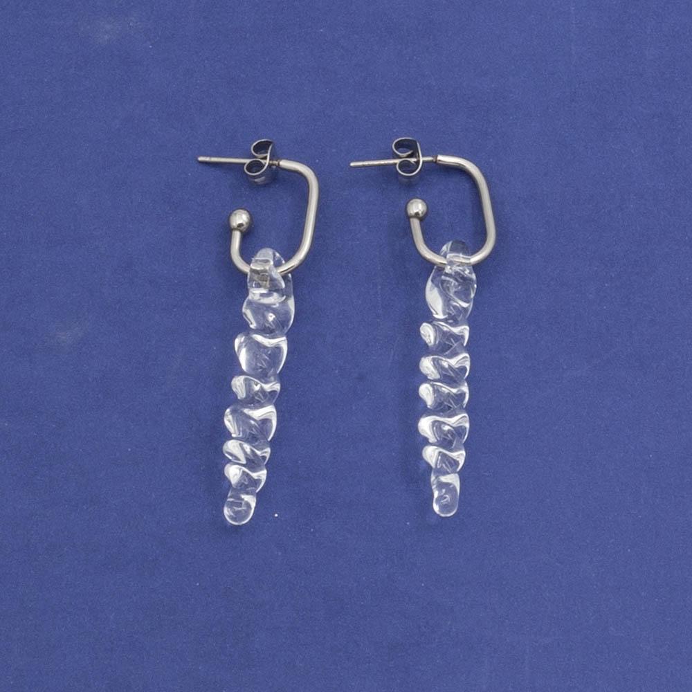 two large clear icicle glass icicles on oval earring hoops with butterfly backs laid flat
