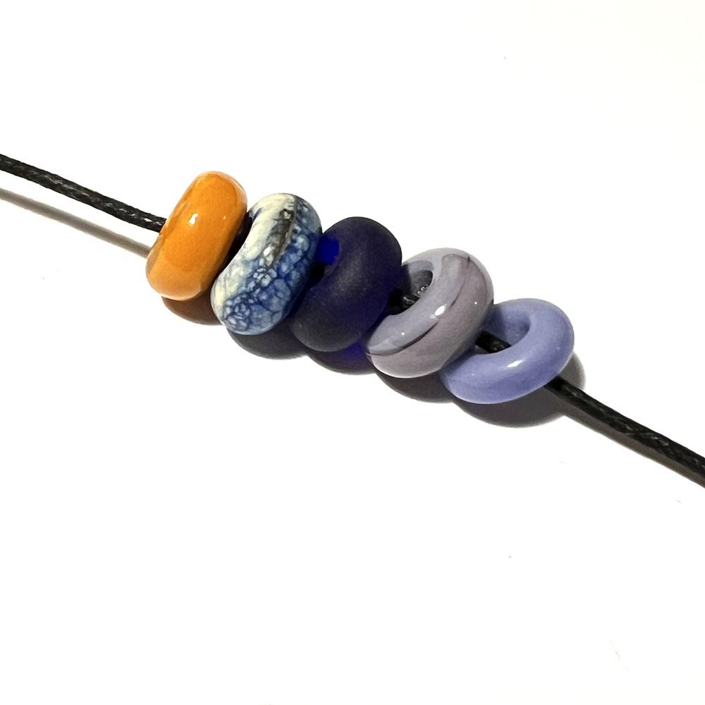 five big holes beads in bright yellow, blues and purples